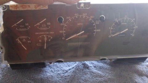 1994 Ford Bronco - A close-up view of a vehicle's instrument cluster, showing various gauges and indicators.