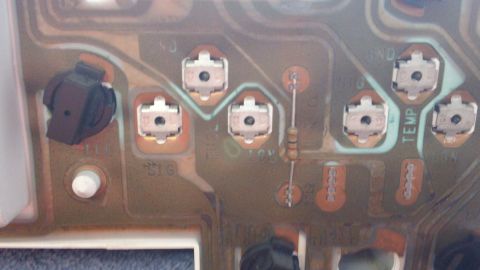 1994 Ford Bronco - Close-up of a circuit board, possibly from an instrument cluster, showing various electronic components and labels like 'TEMP'.