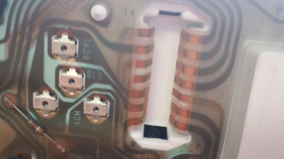 Close-up of an instrument cluster circuit board with copper traces and connectors
