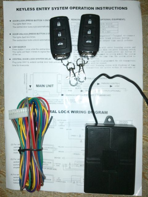 1998 Ford Crown Victoria - Keyless entry system components laid out on a document with instructions and a wiring diagram.