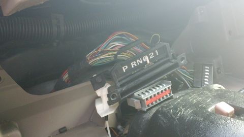 1994 Ford Bronco - Close-up of a vehicle's gear shifter indicator with visible wiring and connectors.