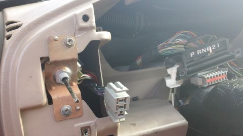1994 Ford Bronco - Dashboard wiring and transmission shifter linkage with PRN021 label. This photo is consistent with a 1994 Ford Bronco.