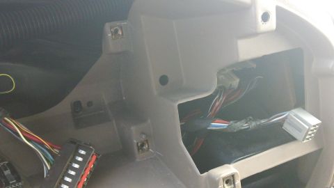 1994 Ford Bronco - Exposed wiring harness and connectors in a vehicle's dashboard area.