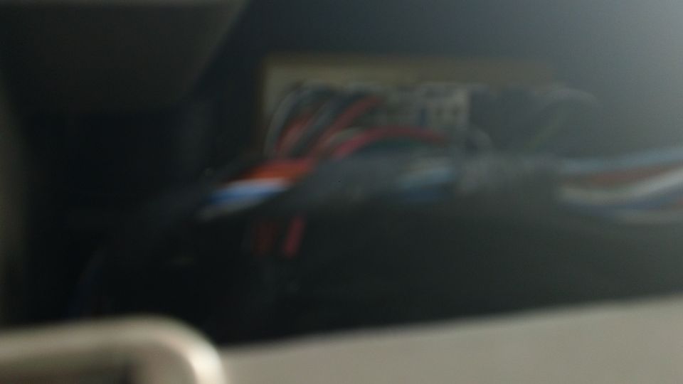 Close-up of colorful wires bundled together, possibly part of a vehicle's electrical system