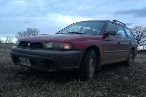 1998 Subaru Legacy - This 1998 Subaru Outback wagon is seen from the front quarter angle in an outdoor setting.