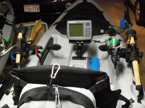 1953 Ford Mainline - A kayak is set up with fishing equipment, including rod holders and a fish finder, ready for use.