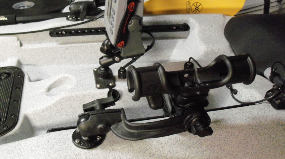 Kayak interior with fishing rod holders and fish finder mounted