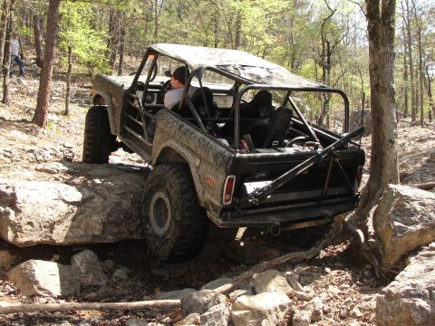 1967 Ford Mustang - This off-road vehicle is navigating a rocky trail in a wooded area.