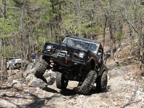 1967 Ford Mustang - A black Ford Bronco tackles a challenging rocky trail, with another vehicle visible in the background.