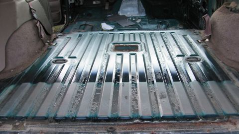 1992 Ford Bronco - Vehicle interior with ribbed flooring, likely undergoing a tear-down or restoration process.
