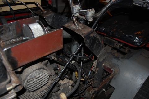 2010 Kawasaki BAYOU 220 - The photo shows the engine and seat area of an ATV, with visible wiring and custom metalwork.