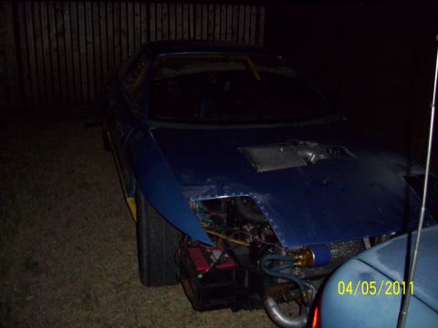1995 Ford Probe - A blue car with its front end disassembled, revealing engine components and wiring.