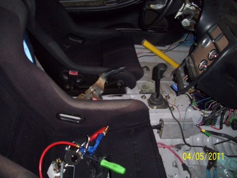 1995 Ford Probe - Interior view of a car's cabin, racing seats, a manual transmission, and extensive exposed wiring, with a visible date stamp.