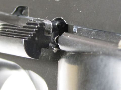 1995 Mercury Grand Marquis - A detailed view of a firearm's internal components, focusing on the slide and hammer assembly.