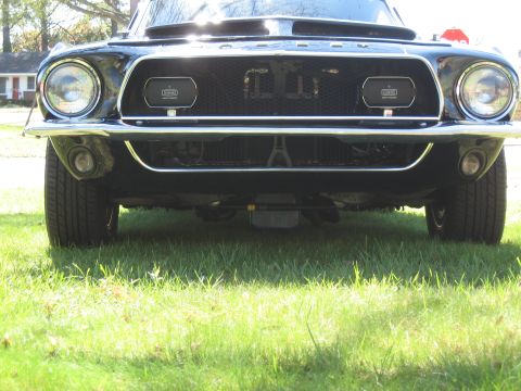 1968 Shelby GT500 - Front view of a black 1968 Shelby GT500, showing its distinctive grille and headlights.