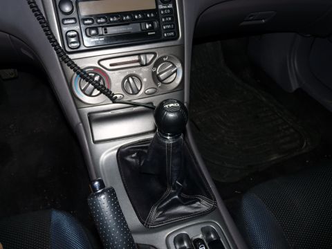 2006 Ford E350 - Close-up of the center console and shifter of a manual transmission vehicle, a TRD shift knob.