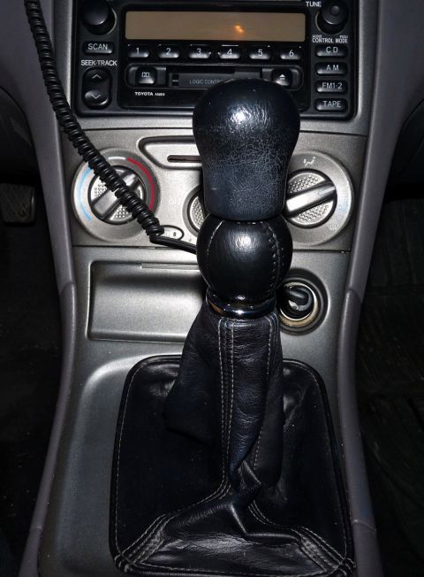 2006 Ford E350 - Close-up of a car's center console, the gear shifter and audio system.