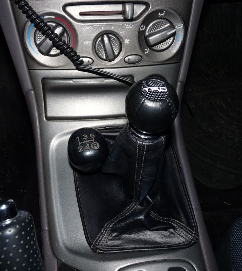 2006 Ford E350 - A close-up view of a car's center console, highlighting the manual transmission shifter and its gear pattern.