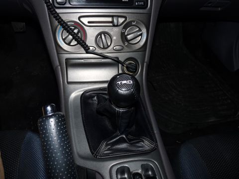 2006 Ford E350 - Interior view of a car's center console a TRD shift knob and climate controls.