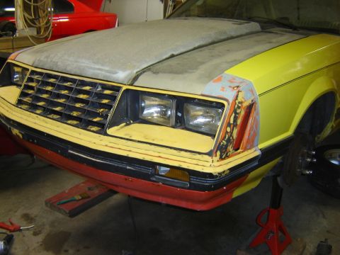 1979 Ford Mustang - This car's front end is in a state of repair, with primer on the hood and mismatched paint on the fender.