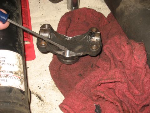 1990 Ford F-250 - A driveshaft U-joint is being worked on with a file, resting on a red cloth.