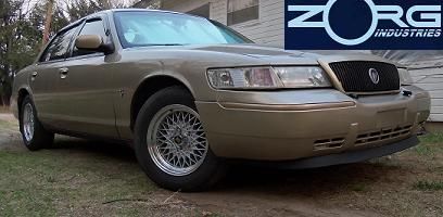 2000 Mercury Grand Marquis - Gold 2000 Mercury Grand Marquis with aftermarket wheels.