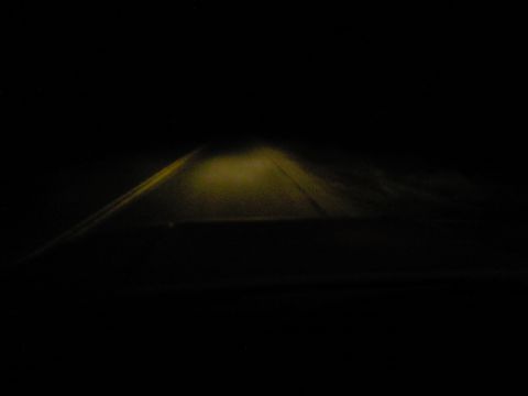 1989 Ford Bronco - The view from the driver's seat on a dark, unlit road.