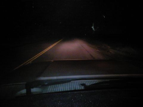 1989 Ford Bronco - Driving at night through fog on a road with double yellow lines, seen from the dashboard.