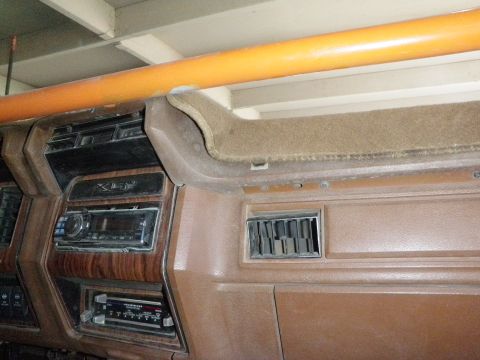 1982 Ford Bronco - Interior view of a vehicle's dashboard, showing radios and a roll cage.