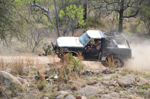 1986 Ford Bronco - This 1986 Ford Bronco is equipped for off-road adventures, kicking up dust on a trail.