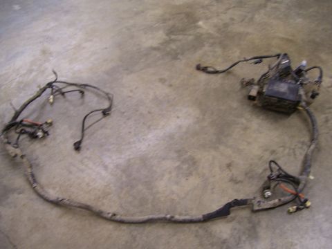 1991 Ford Bronco - A vehicle wiring harness with multiple connectors and a black box is shown on a concrete surface.
