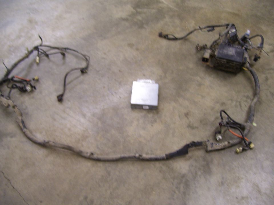 Engine wiring harness and silver computer module on concrete floor