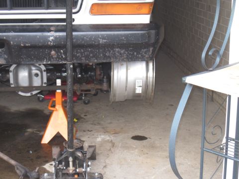 1979 Ford Bronco - Front suspension of a 1979 Ford Bronco is supported by jack stands for maintenance.