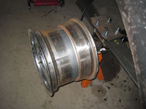 1979 Ford Bronco - Close-up of a vehicle's wheel and suspension system, showing leaf springs and mounting hardware.