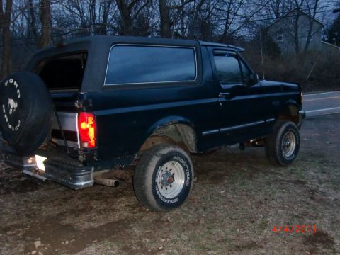 1993 Ford Bronco - This 1993 Ford Bronco is seen from the rear quarter angle, a spare tire mounted on the back.