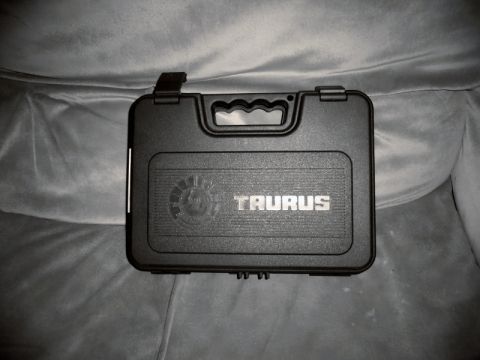 2000 Mercury Grand Marquis - A black Taurus gun case rests on a textured gray surface, with a Supermotors.net watermark in the lower right corner.