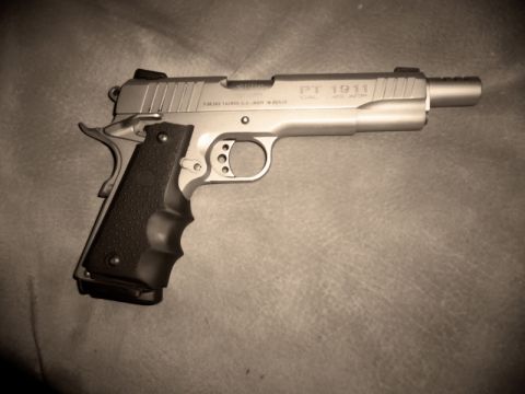 2000 Mercury Grand Marquis - Taurus PT 1911 pistol shown on a textured surface.