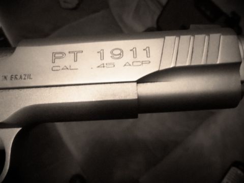 2000 Mercury Grand Marquis - Close-up of a PT 1911 pistol slide, showing caliber and origin markings.