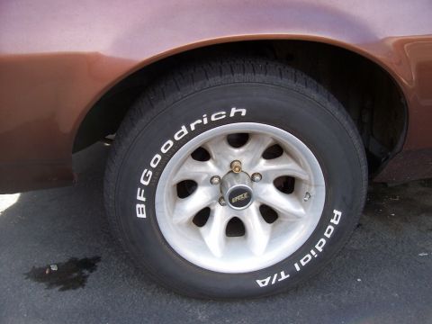1972 Ford Ranchero - Close-up of a BFGoodrich Radial T/A tire and silver wheel on a brown vehicle.