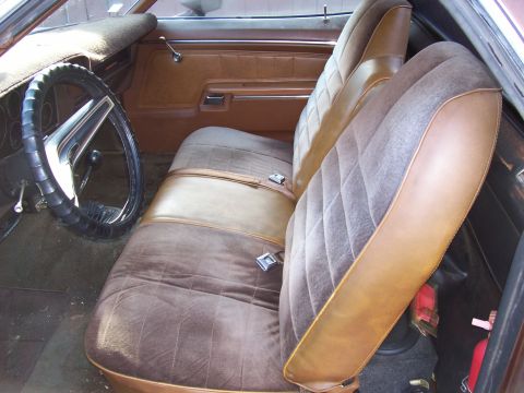 1972 Ford Ranchero - The interior of a 1972 Ford Ranchero shows brown upholstery and a classic steering wheel.