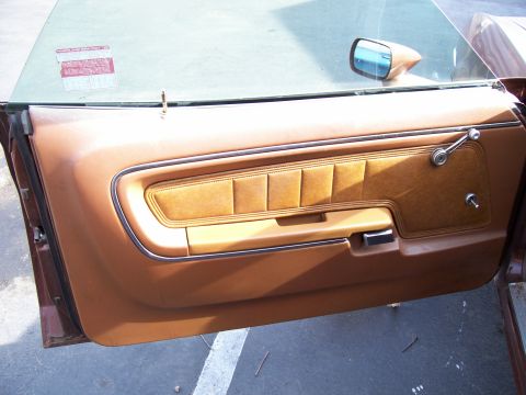 1972 Ford Ranchero - Interior view of a 1972 Ford Ranchero door panel, showing the brown upholstery and chrome accents.