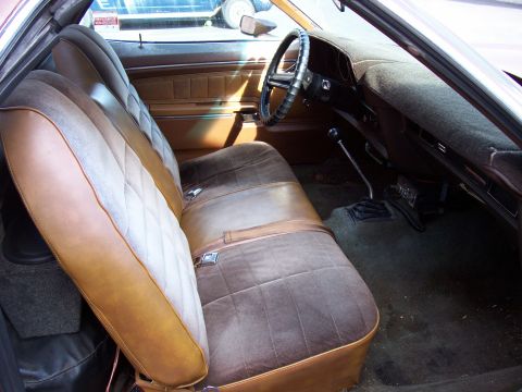 1972 Ford Ranchero - The interior of the vehicle shows brown and tan seats with a diamond pattern and a dark dashboard.
