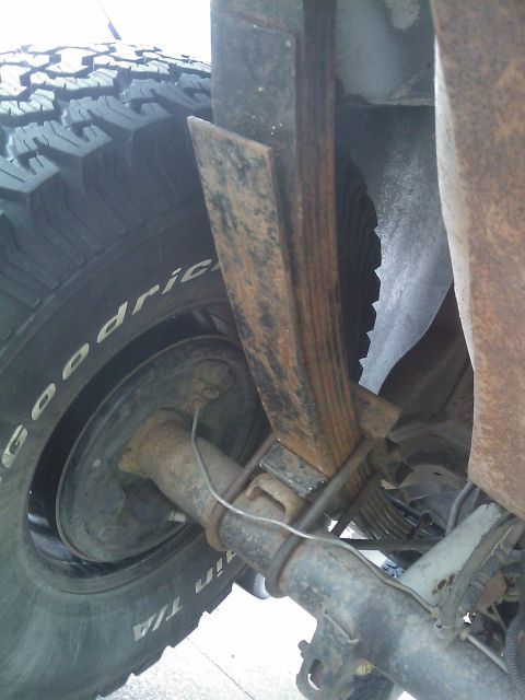1994 Ford Bronco - The rear suspension components, including leaf springs and axle, are shown in this close-up photograph.