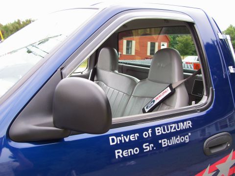 1998 Ford F-150 - The interior of a blue Ford truck is shown, gray seats and a Ford Racing branded seatbelt cover.