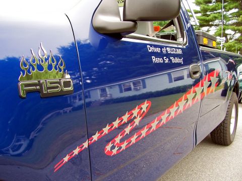 1998 Ford F-150 - Custom graphics on a 1998 Ford F-150, including flames and patriotic stars.