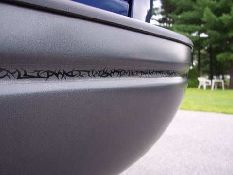 1998 Ford F-150 - Gray truck rear bumper features a tribal graphic strip along the body line.