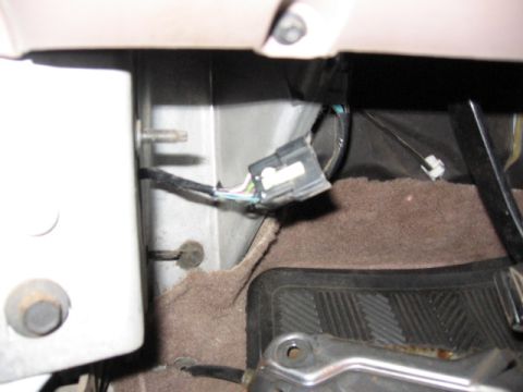 1995 Ford Bronco - remove drivers kick panel, and the 3 small bolts for the emergency brake and pull that out of the way and you will find the plug. Then you…
