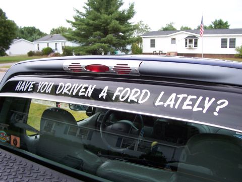 1998 Ford F-150 - A white decal on the rear window of a Ford truck asks "HAVE YOU DRIVEN A FORD LATELY?"