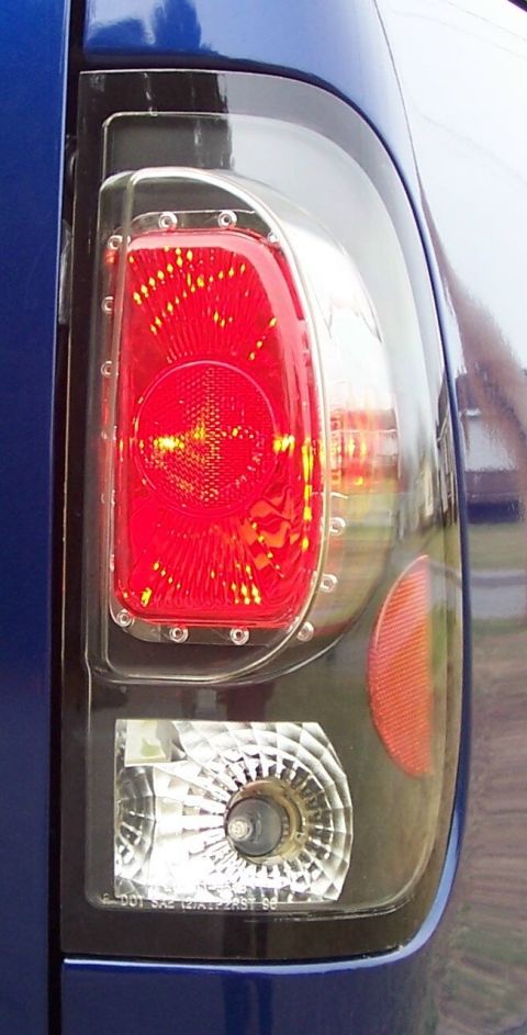 1998 Ford F-150 - Aftermarket tail light assembly with clear lens and red/white sections.