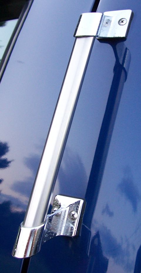 1998 Ford F-150 - A chrome grab handle is mounted on the blue body of a vehicle. The reflection shows clouds.